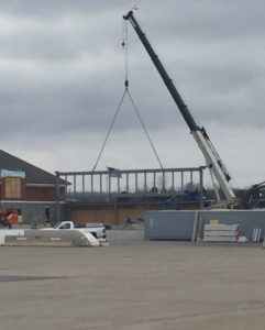a crane lifting a steel truss