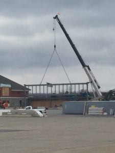 a crane lifting a steel truss